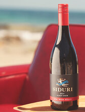 Bottle of Siduri Sta. Sita Hills Pinot Noir on the beach