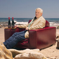 Siduri Wines winemaker, Adam Lee, sitting on the beach with wine